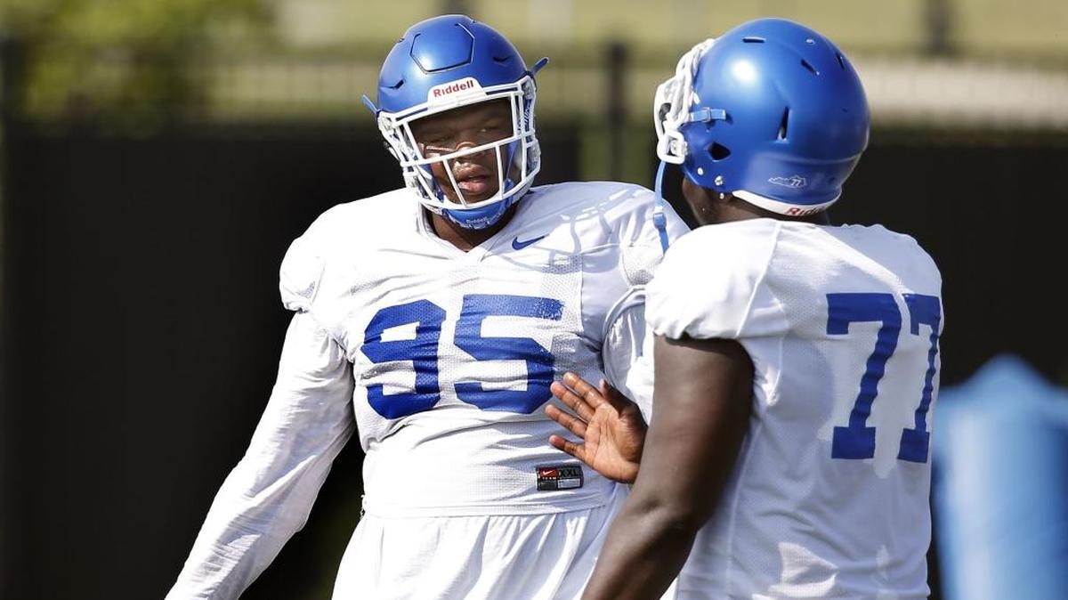 Kentucky defensive Lineman Quinton Bohanna, 95, talked to Naquez Pringle during a break in drills during practice held at the UK football practice facility on Alumni Dr. in Lexington, Ky., Tuesday, August 22, 2017.