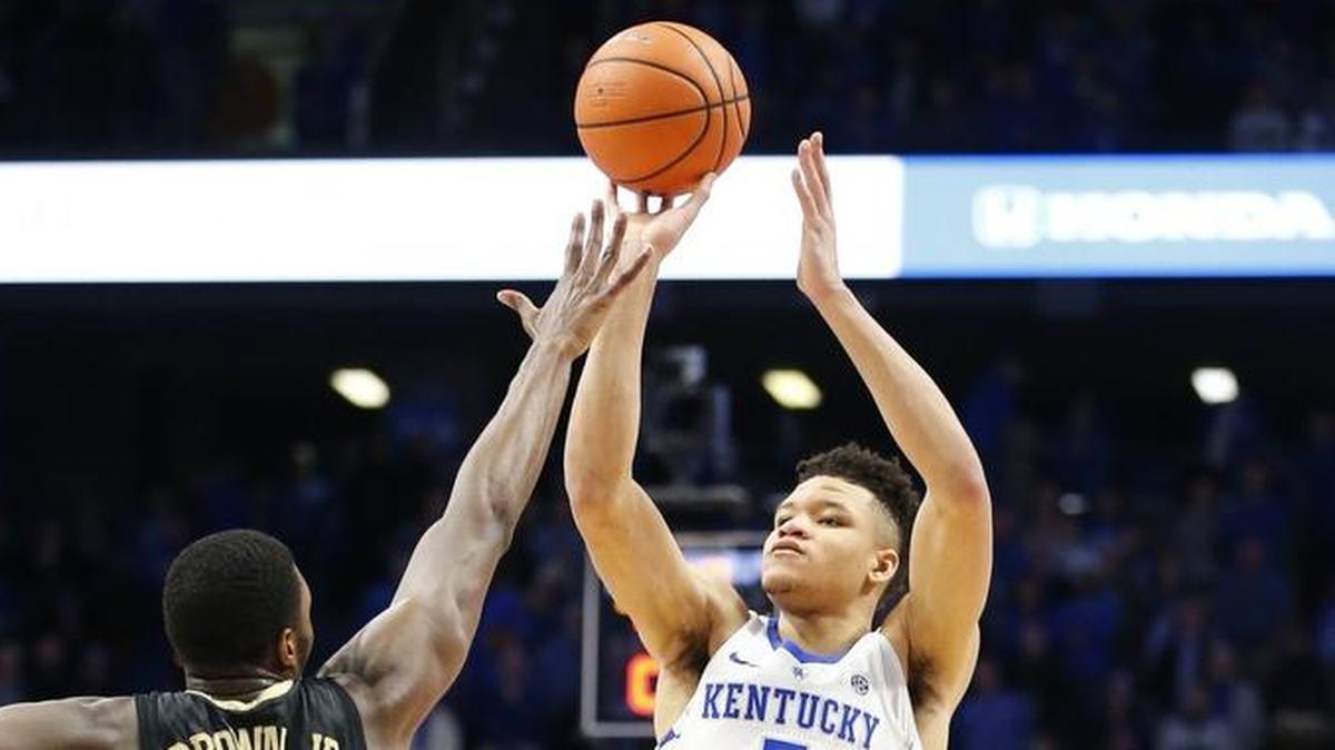 Kentucky forward Kevin Knox (5) shoots a three-pointer while being defended by Vanderbilt forward Clevon Brown (15) during UK’s 83-81 overtime win at Rupp Arena in Lexington, Ky., Tuesday, Jan. 30, 2018.