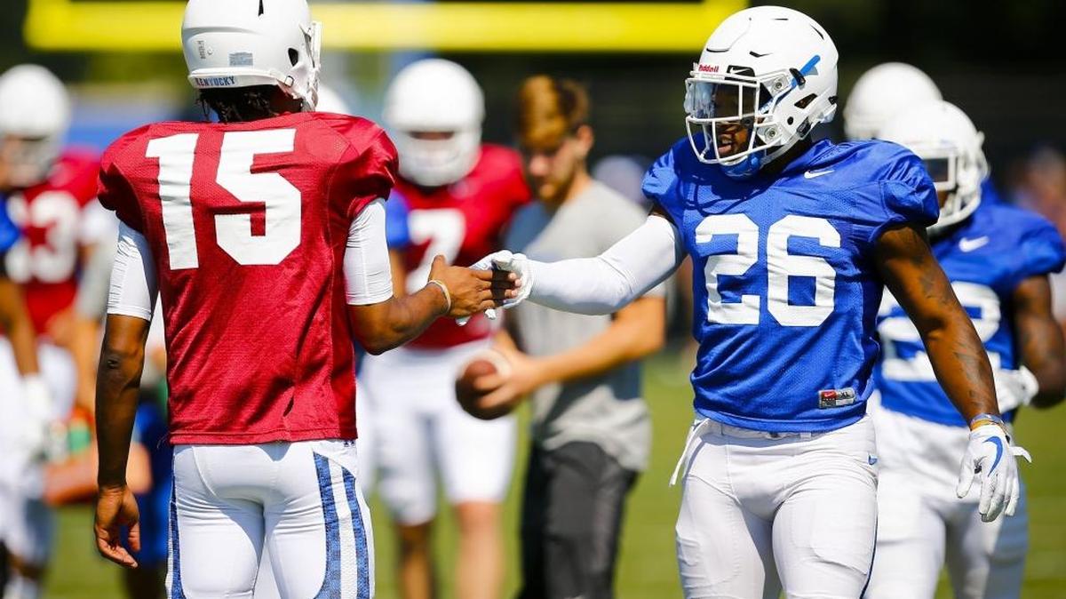 Kentucky quarterback Stephen Johnson (15) and running back Benny Snell Jr. (26) congratulate each other during football practice at the Joe Craft Football Training Center in Lexington, Ky., Saturday, Aug. 5. 2017.