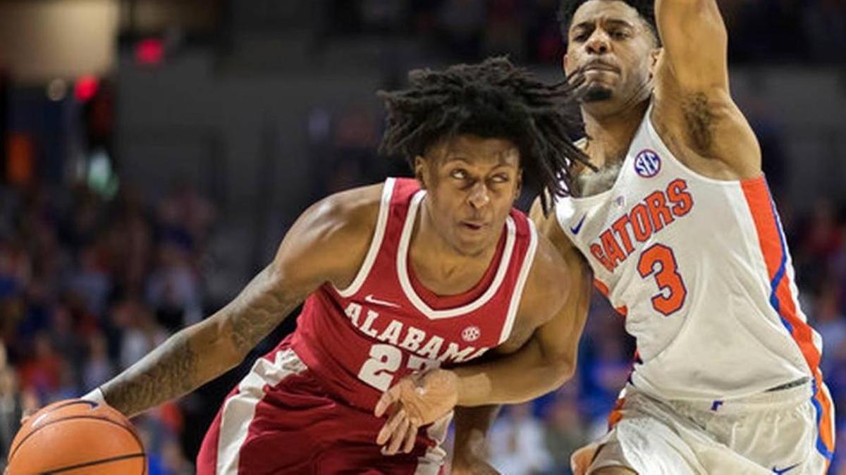 Alabama guard John Petty (23) dribbles past Florida guard Jalen Hudson during the Crimson Tide’s 68-50 win over the Gators in Gainesville, Fla. on Saturday, Feb. 3, 2018.
