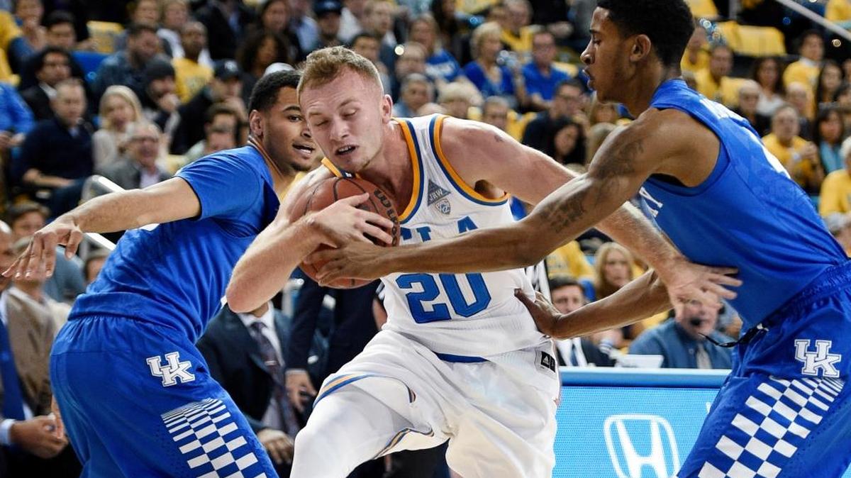 UCLA guard Bryce Alford, center, attempts to move the ball past Kentucky guard Charles Matthews, right, as Jamal Murray, left, helps defend during the first half of an NCAA college basketball game in Los Angeles, Thursday, Dec. 3, 2015.
