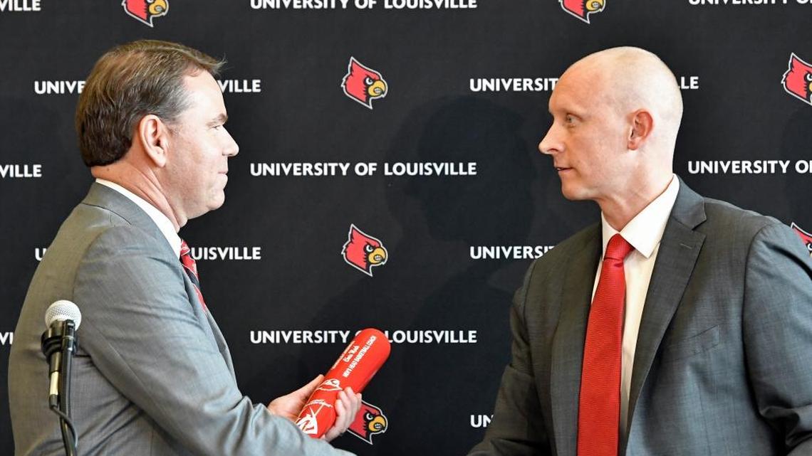 University of Louisville athletic director Vince Tyra, left, shakes hands with Chris Mack after Mack was introduced as Louisville’s new head basketball coach during an NCAA college basketball press conference on Wednesday, March 28, 2018, in Louisville, Ky.