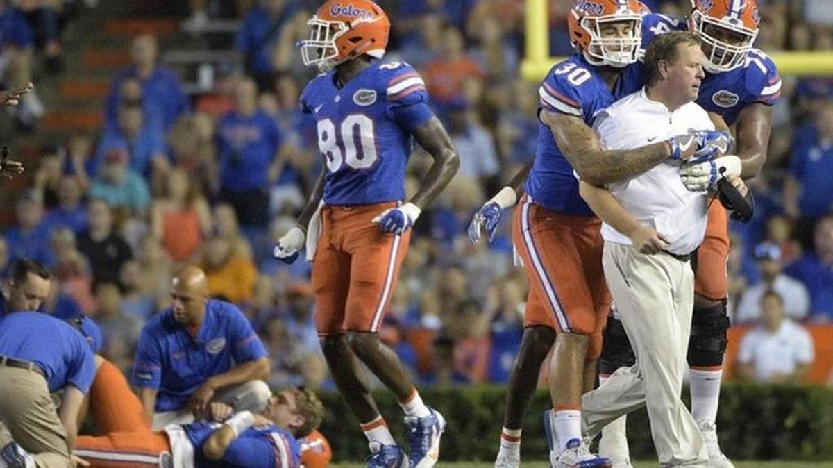 Florida coach Jim McElwain had to be held back by his players after the Gators’ quarterback Luke Del Rio was injured in Saturday’s win over North Texas.
