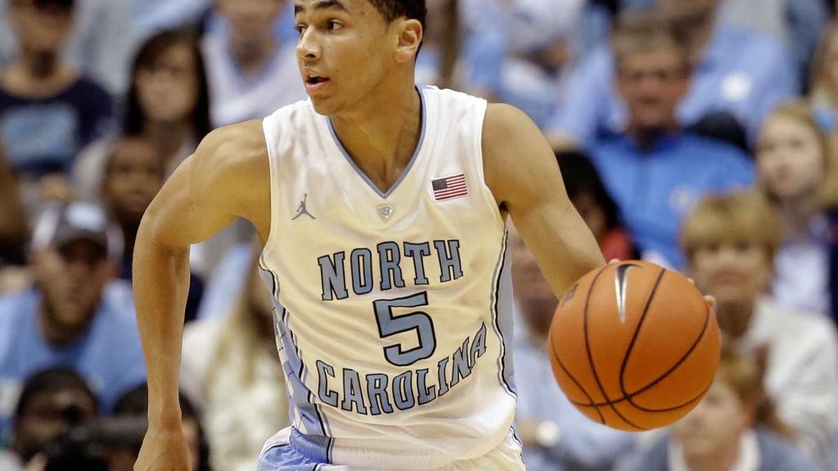 FILE - In this Dec. 18, 2013, file photo, North Carolina's Marcus Paige dribbles against Texas during the second half of an NCAA college basketball game in Chapel Hill, N.C. North Carolina is hoping senior Paige will be back in time from a broken hand that he could play against highly ranked Maryland on Tuesday, Dec. 1, 2015, in the ACC/Big Ten Challenge.