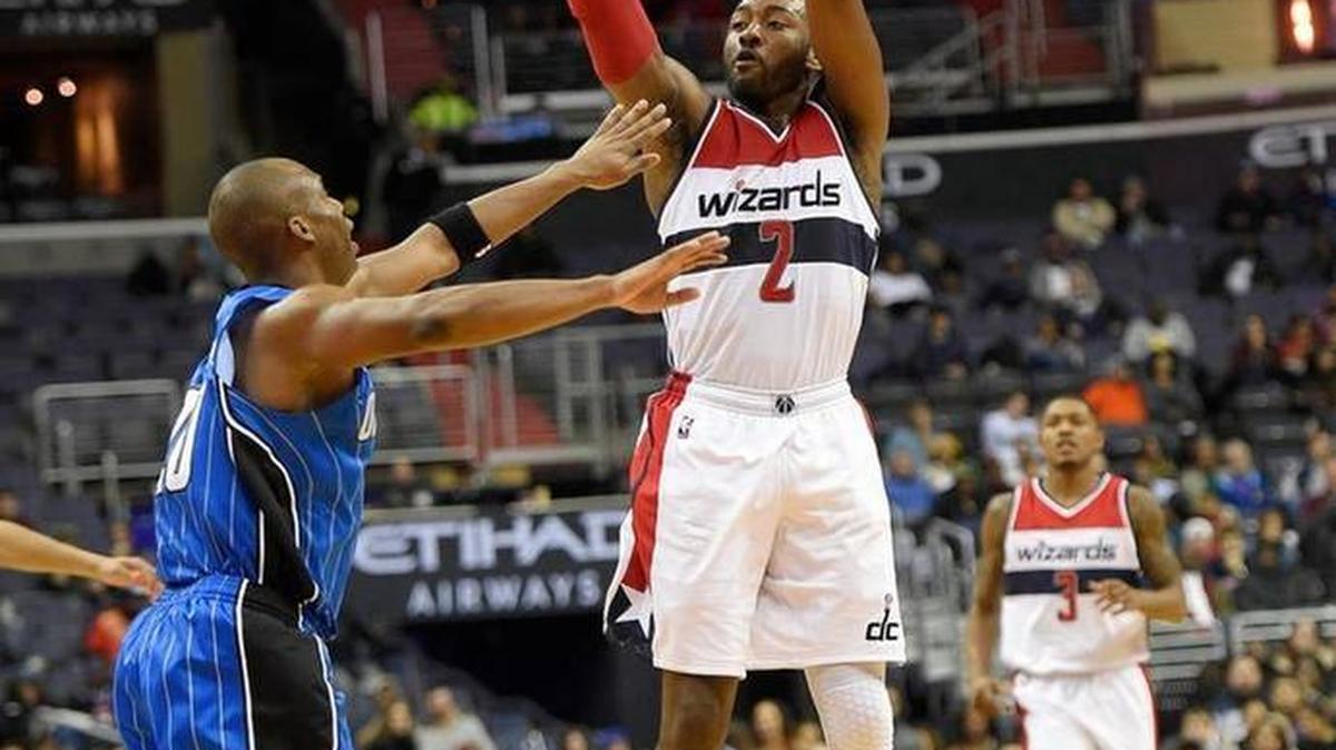 Washington Wizards guard John Wall (2) takes a shot against Orlando Magic guard Jodie Meeks, left, on the way to scoring a career-high 52 points in the Wizards’ 124-116 loss on Tuesday, Dec. 6, 2016, in Washington.