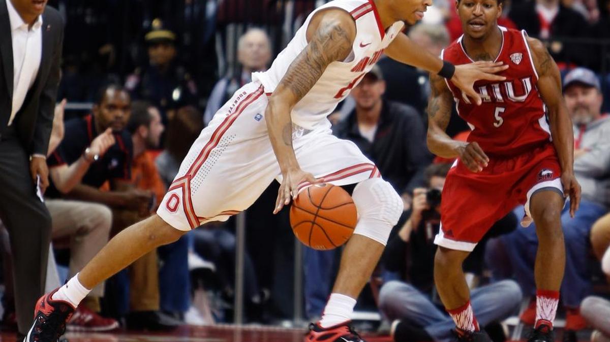 Ohio State's Marc Loving, left, tries to dribble past Northern Illinois' Travon Baker during the first half of an NCAA college basketball game Wednesday, Dec. 16, 2015, in Columbus, Ohio.