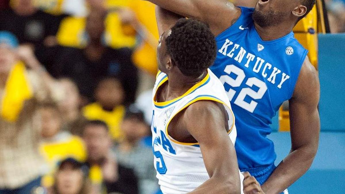 UCLA's guard Prince Ali slams home a basket over Kentucky forward Alex Poythress, right, and is fouled during the second half of an NCAA college basketball game in Los Angeles, Thursday, Dec. 3, 2015. UCLA won 87-77.