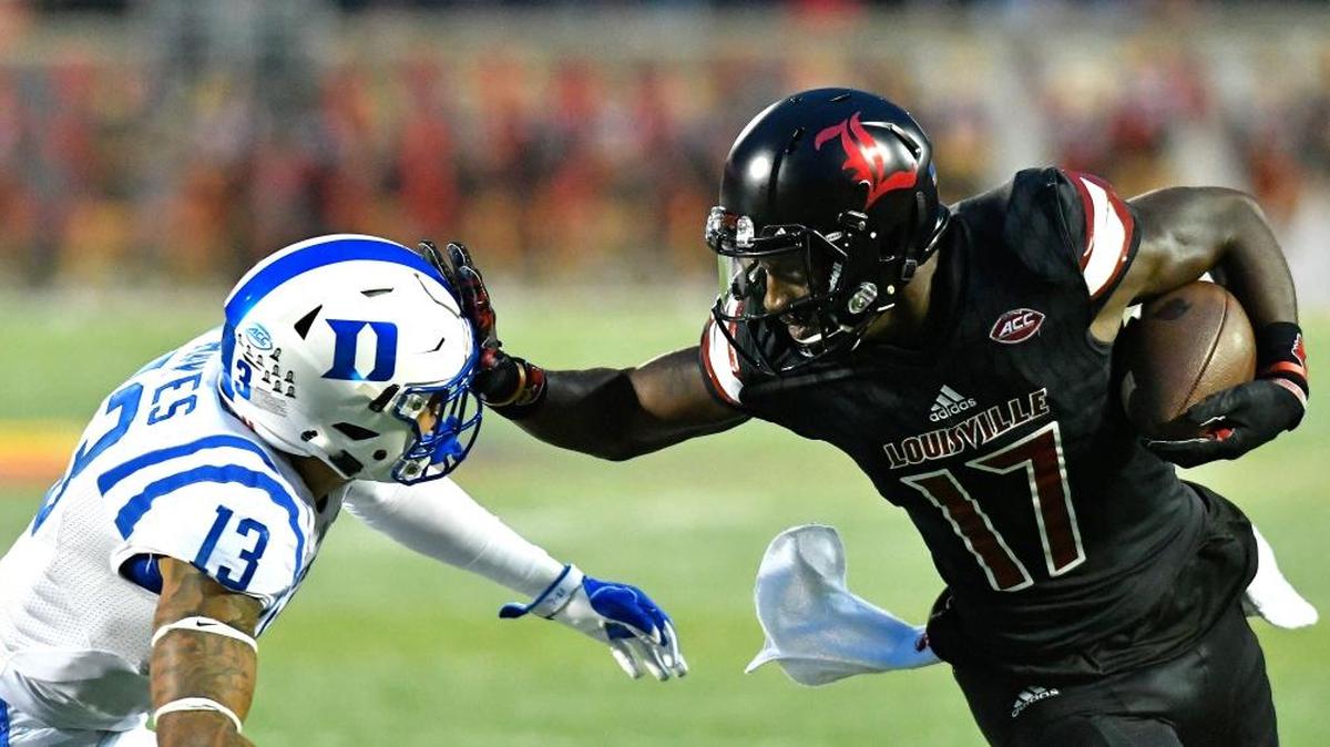 Louisville wide receiver James Quick (17) pushes off a tackle by Duke’s Jordan Hayes (13) during the first half of an NCAA college football game, Friday, Oct. 14, 2016, in Louisville, Ky.