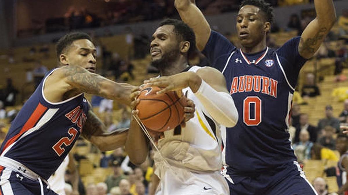 Missouri’s Kevin Puryear tries to hold on to the ball while being guard by Auburn’s Bryce Brown, left, and Horace Spencer, right, during Auburn’s 77-72 win in Columbia, Missouri on Tuesday, Jan. 10, 2017.