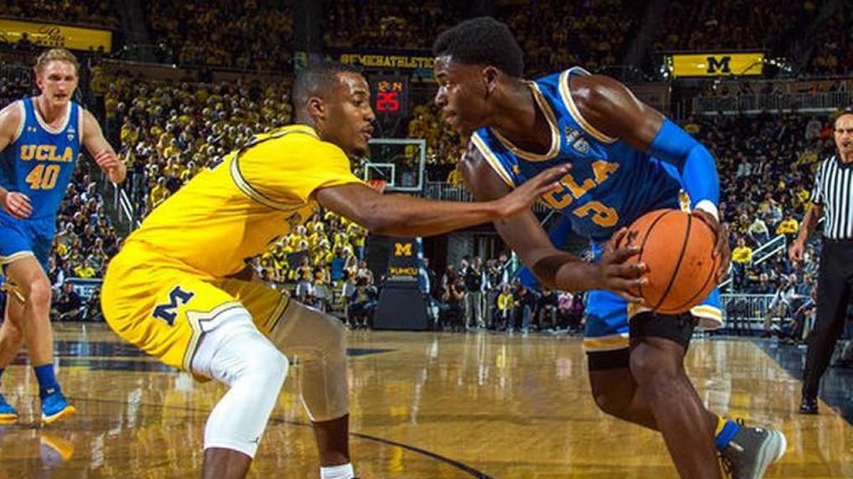 Michigan guard Muhammad-Ali Abdur-Rahkman, left, defends UCLA guard Aaron Holiday (3) in the first half of Michigan’s overtime win over the Bruins in an NCAA college basketball game at Crisler Center in Ann Arbor, Mich., Saturday, Dec. 9, 2017.