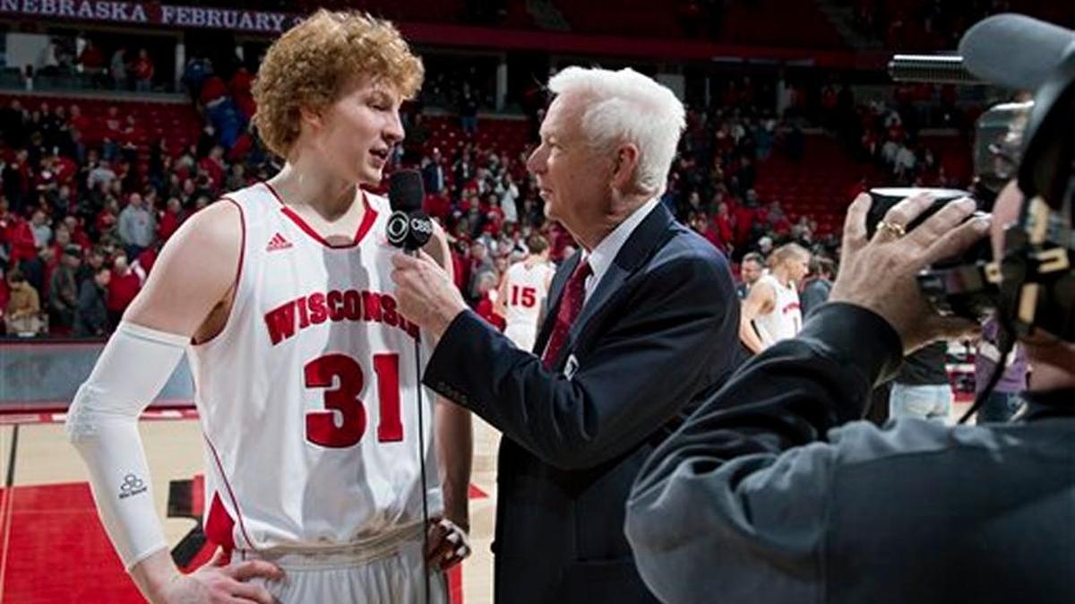CBS analyst Bill Raftery interviews Wisconsin Badgers forward Mike Bruesewitz (31) after a Big Ten Conference NCAA college basketball game against the Ohio State Buckeyes Sunday, February 17, 2013, in Madison, Wis. The Badgers won 71-49.