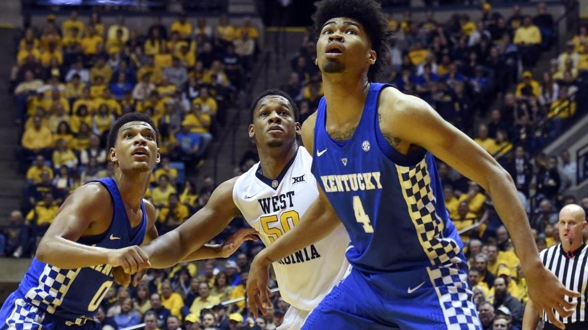 Kentucky's Nick Richards (4), Quade Green (0) and West Virginia forward Sagaba Konate, center, watch for a rebound during the first half of an NCAA college basketball game Saturday, Jan. 27, 2018, in Morgantown, W.Va. Kentucky won 83-76.