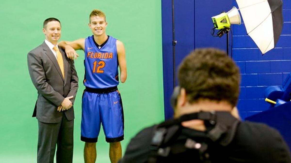 Florida head coach Mike White poses for a photo with Florida guard Zach Hodskins (12) during their NCAA college basketball media day, Tuesday, Sept. 29, 2015, in Gainesville, Fla.